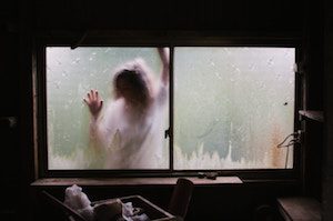 picture of woman outside window blurred